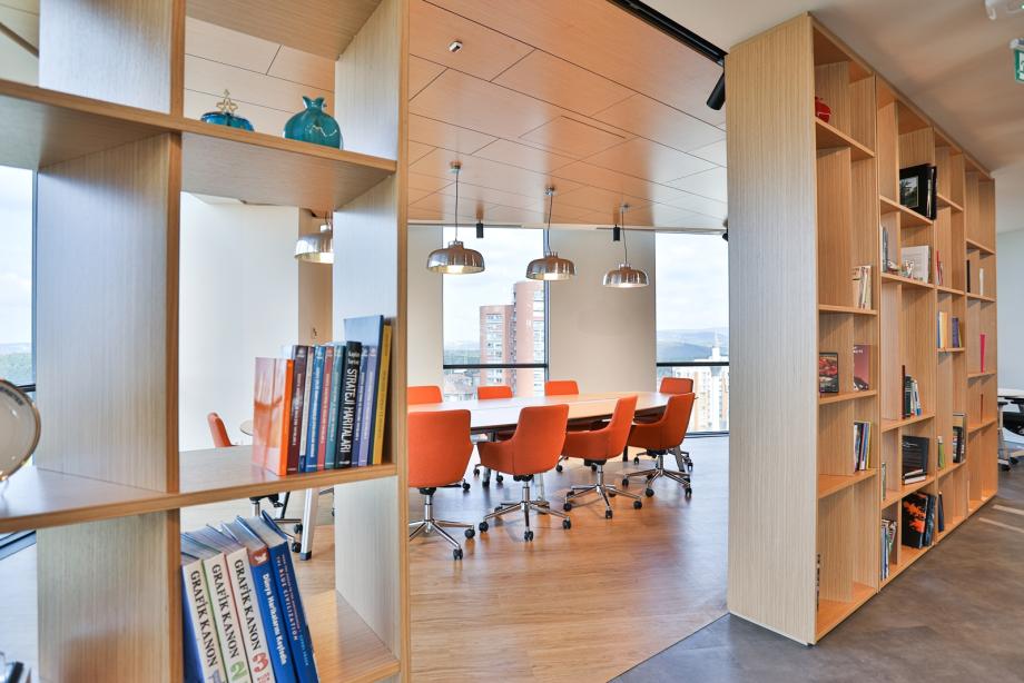 Voorbeeld van een werkplekadviesproject van Studio Alliance met een vergaderruimte met grote boekenkasten en uitzicht op de stad